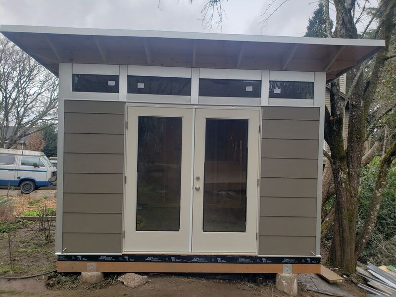 Completed dark studio shed, front view by ArchAngel Construction Services