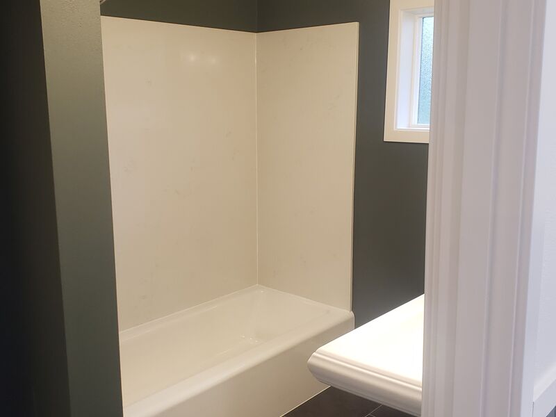 Bathroom remodel with pedestal sink and toilet by ArchAngel Construction Services