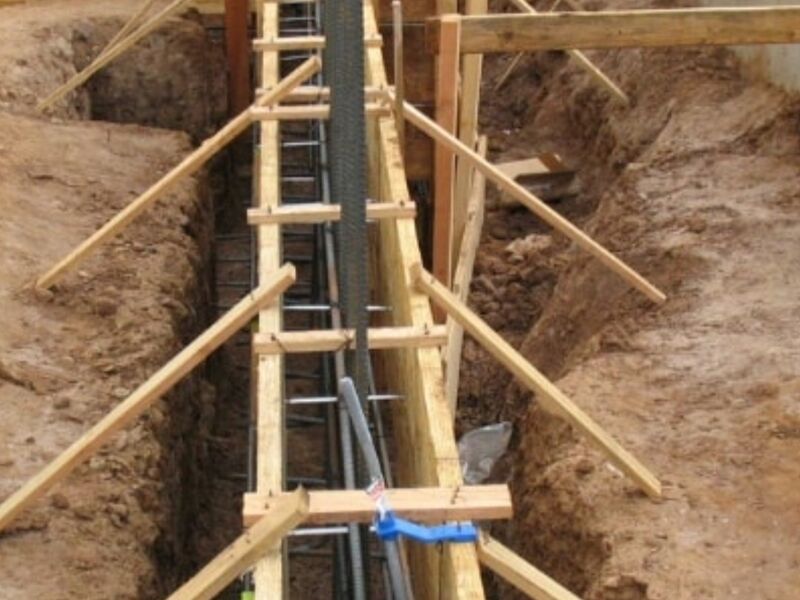Concrete footing trench with rebar reinforcement by ArchAngel Construction Services