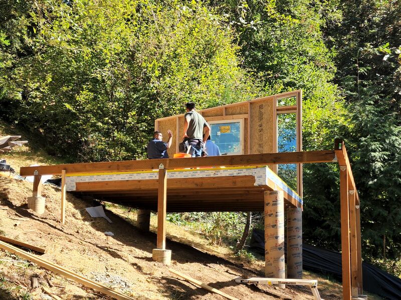 Concrete pier foundation and floor framing by ArchAngel Construction Services