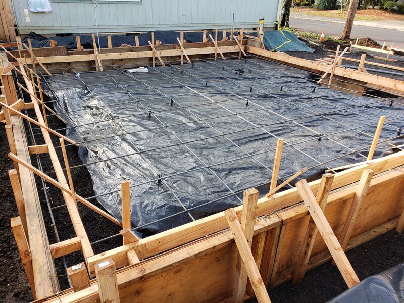 Rebar grid and vapor barrier set for a new foundation slab