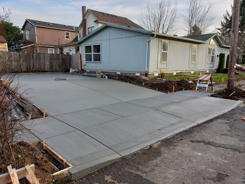 Freshly poured concrete foundation slab and driveway
