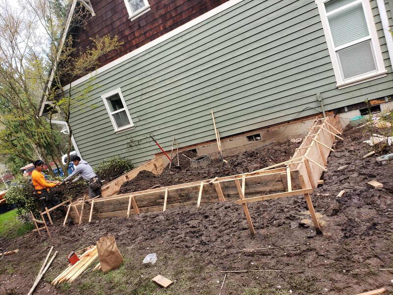 Foundation wall replacement and form work on a sloped lot