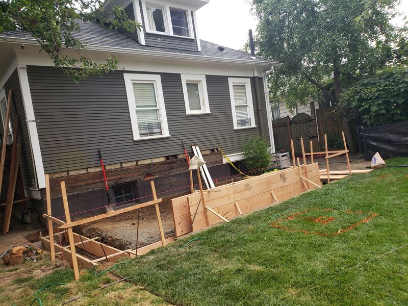 Foundation retrofit with rebar and formwork on an older home