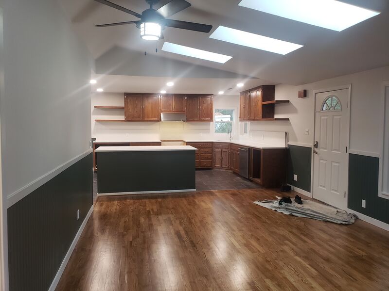Completed kitchen remodel with dark cabinetry and stainless appliances
