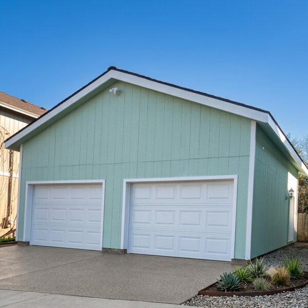 Detached two-car garage new construction with green siding